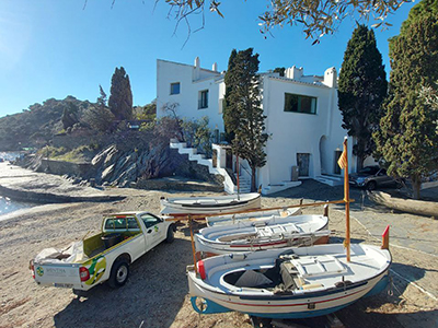 White-walled Salvador Dali House in Portlligat, with surrounding greenery