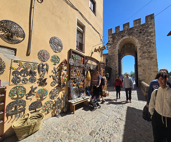 A charming stone portal in Besalú with a small local shop selling souvenirs