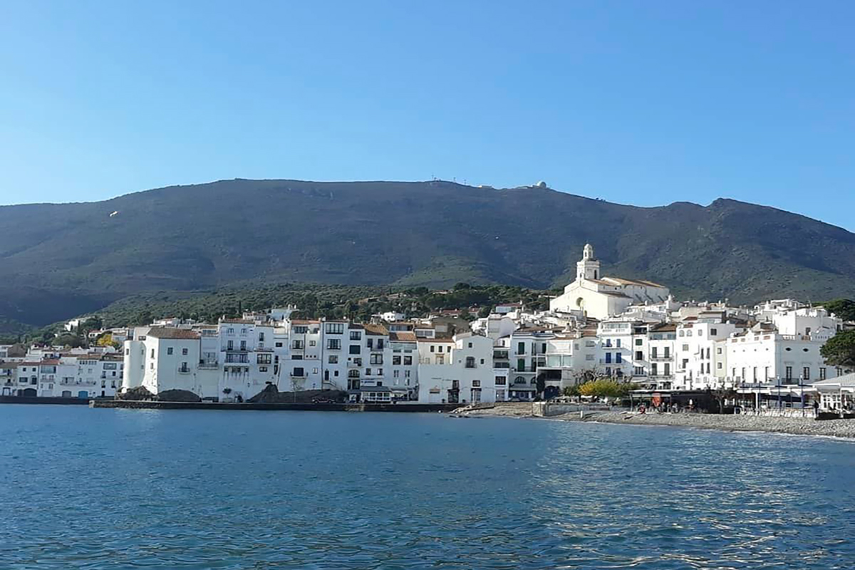 Panoramic view of Cadaqués with whitewashed houses and the Mediterranean Sea