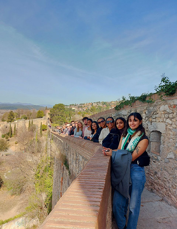 City wall of Girona with a group of students