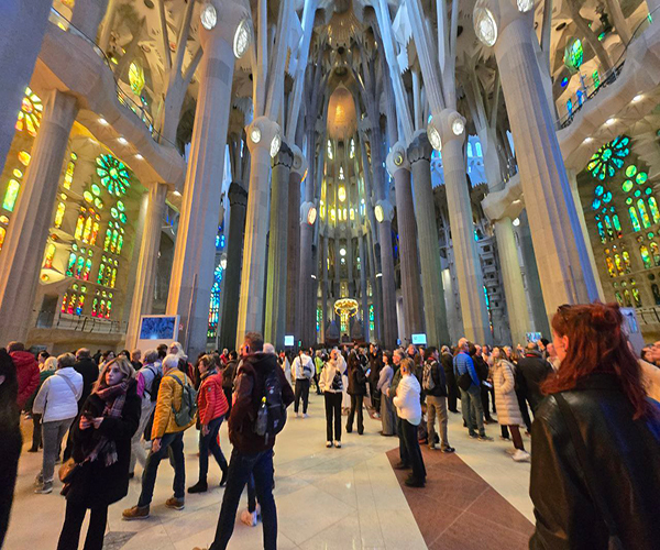 Inside Sagrada Familia - colorful stained glass windows and intricate columns by Gaudí