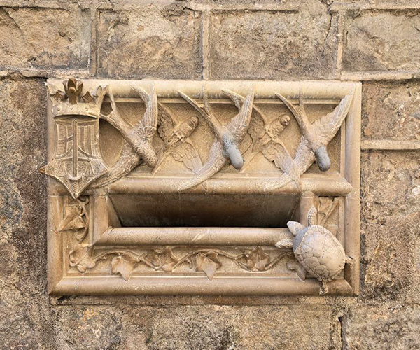 Modernist mailbox in Barcelona - decorated with swallows and a turtle